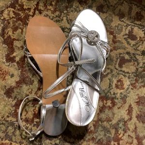 Silver dress shoes with clear stones at toe’s